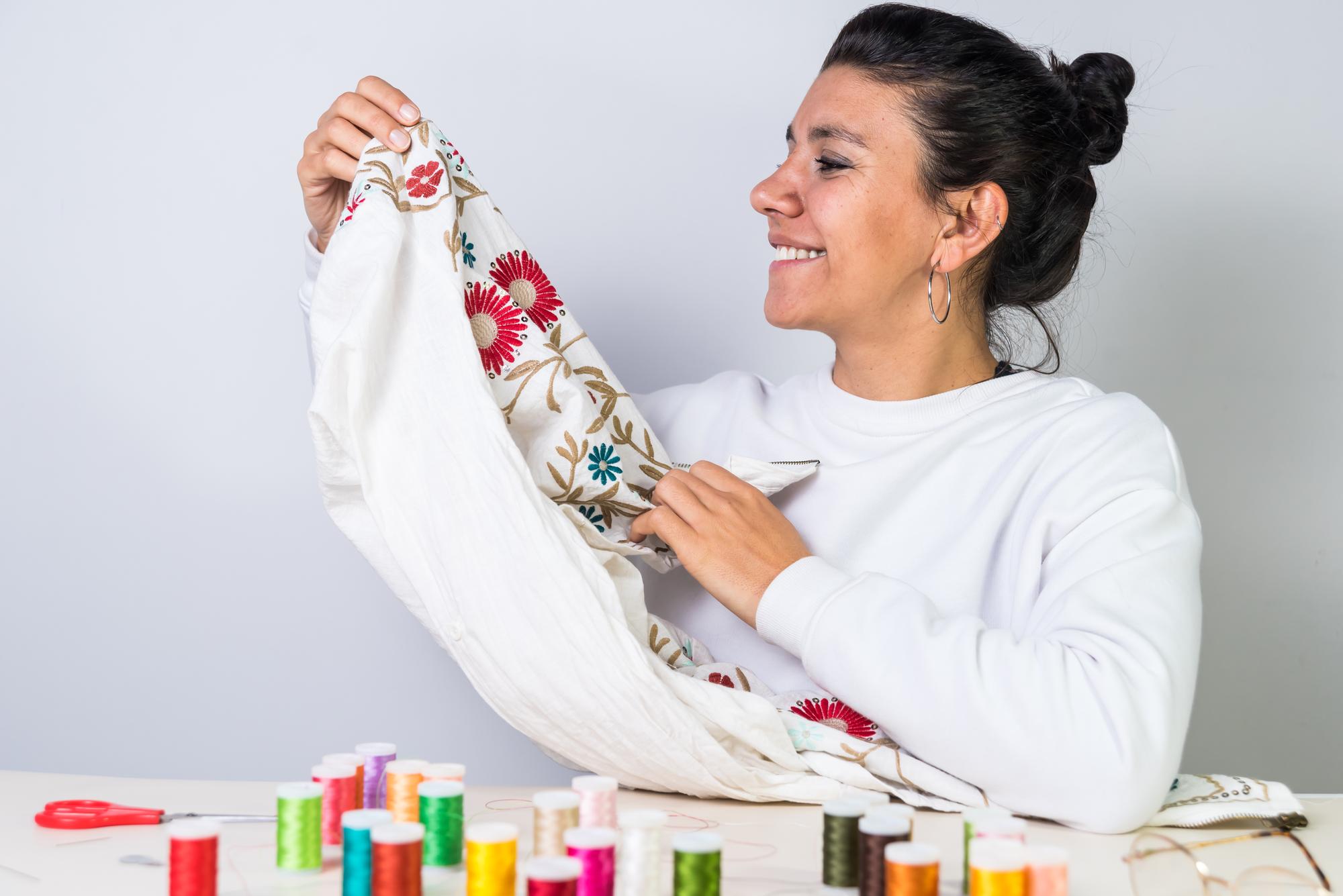 Instructor demonstrating embroidery technique to a small group